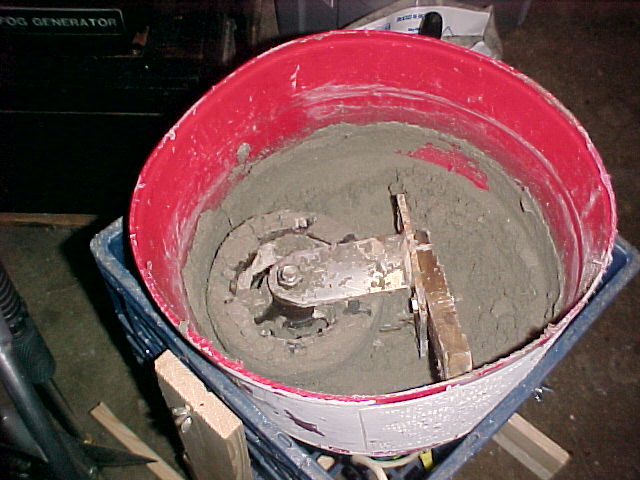 using a caster wheel and a wood scraper the muller blends the sand and clay.jpg